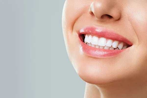 A patient smiling after periodontal treatment at Pikes Peak Periodontics